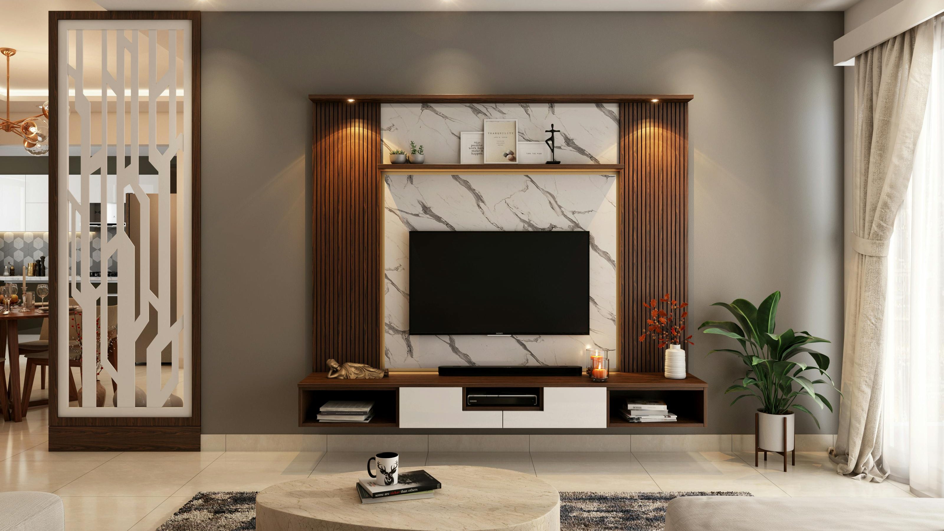 Modern living room with a television unit, decorative elements, and a plant.